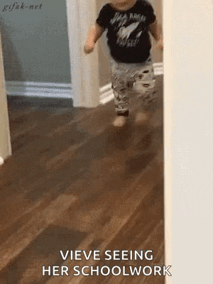 a baby is running down a hallway with the words " vieve seeing her schoolwork " written on the floor .