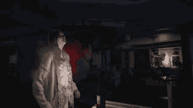 a person is laying on the ground in the dark with sparks flying around them .