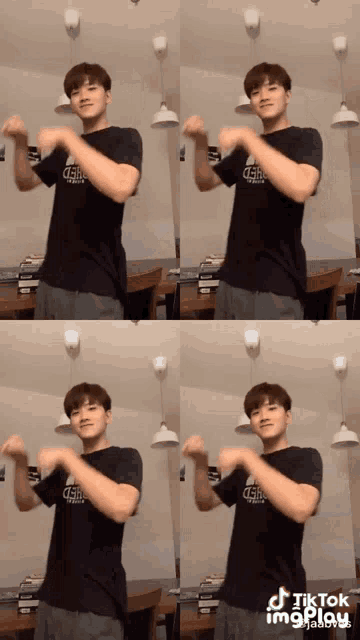 a man wearing a black shirt that says gsb on it is dancing