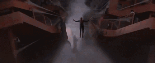 spider-man is flying through the air while holding a spider web .