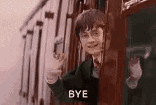 harry potter is waving from the window of a train and saying `` bye '' .