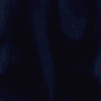a close up of a person with blue hair and a black shirt .