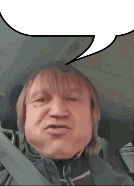 a man in a car with a speech bubble above him