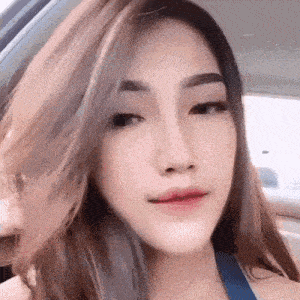 a close up of a woman 's face while sitting in a car with her mouth open .