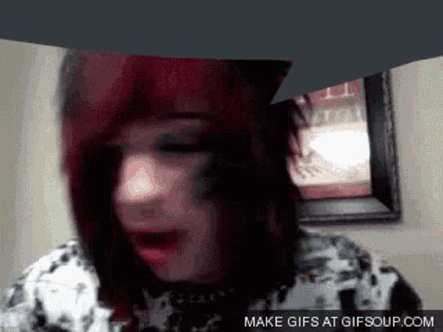 a gif of a person with red hair is displayed on a website called gifsoup.com