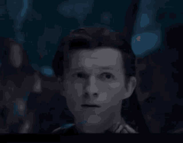 a close up of a man 's face with a blurred background .