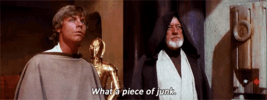 two men are standing next to each other and one of them is saying what a piece of junk