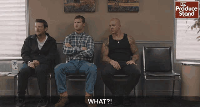 three men sitting in a waiting room with a sign that says produce stand