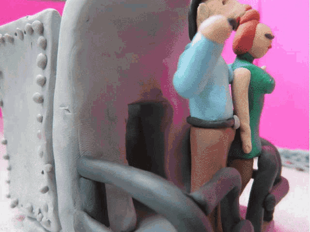 a statue of a man and woman sitting on a chair