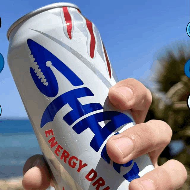 a person is holding a can of star energy drink