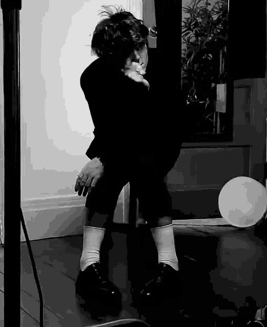 a black and white photo of a person holding a child