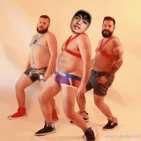 a group of men are dancing together and one of them has a picture of a man on his head .