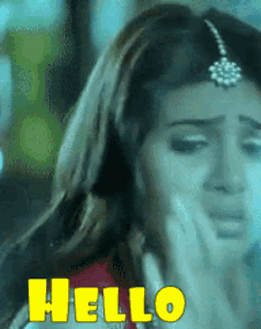 a close up of a woman 's face with the word hello in yellow