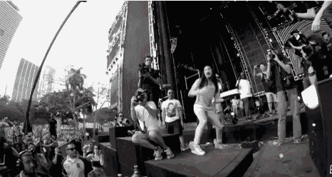a black and white photo of a group of people dancing on a stage .
