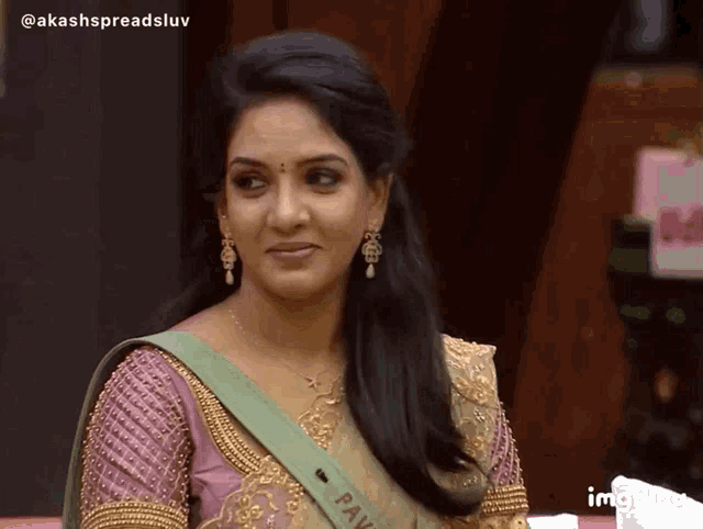 a woman with a green sash that says pav