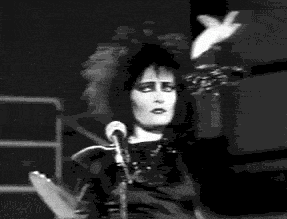 a black and white photo of a person singing into a microphone