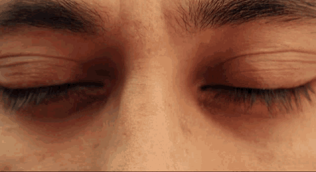 a close up of a person 's eyes with their eyelashes closed
