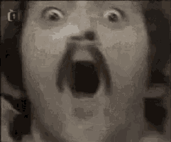 a close up of a man 's face with his mouth open .