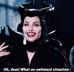 a woman with horns on her head is smiling and says oh dear what an awkward situation .