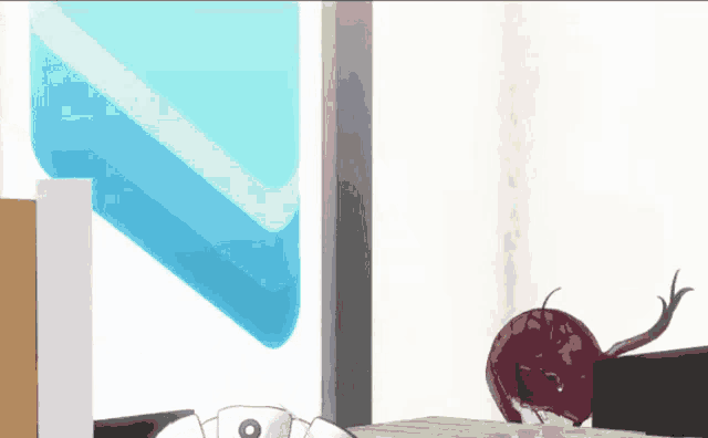 a beet is sitting on a desk next to a computer keyboard