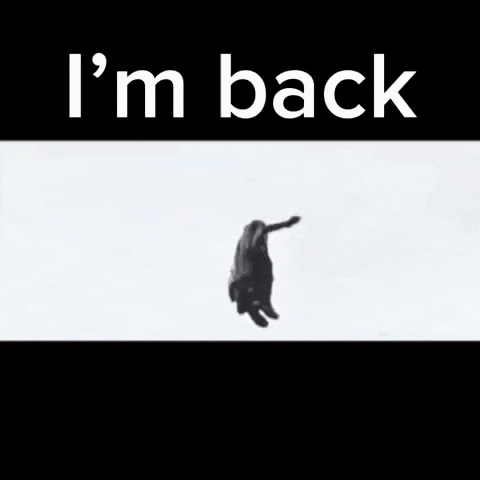 a man in a trench coat is standing in front of a stadium with the words i 'm back below him