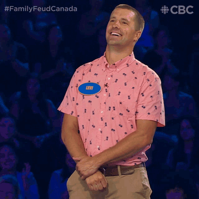 a man wearing a pink shirt with levi written on it