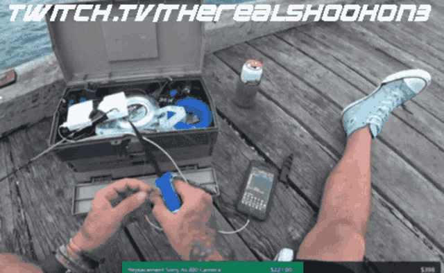 a person sitting on a wooden dock with a twitch.tv watermark