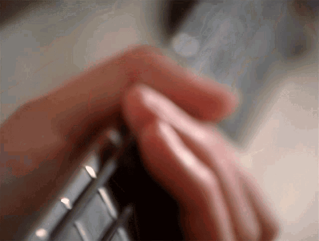 a close up of a person 's hand playing a keyboard