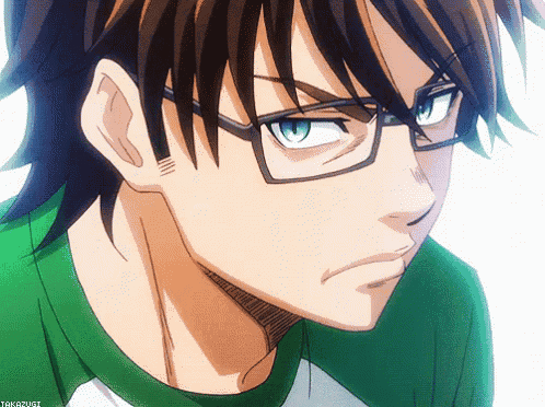 a close up of a person wearing glasses and a green shirt that says takougi