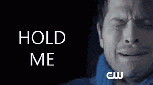 a man is crying in front of a black background with hold me written on it