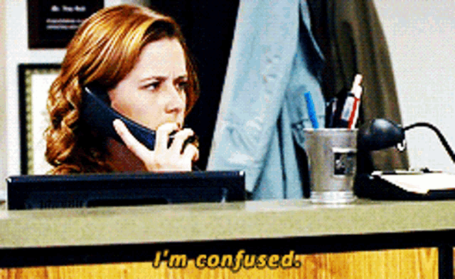 a woman talking on a cell phone with i 'm confused written on the counter