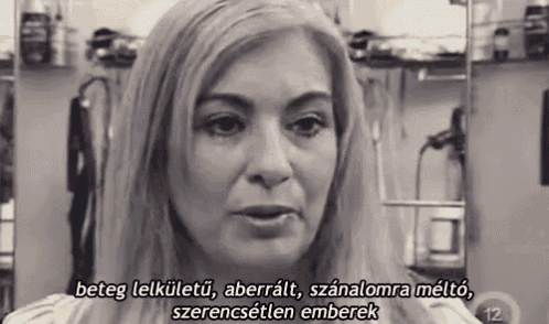 a woman with blonde hair is talking in a black and white photo with foreign language subtitles .