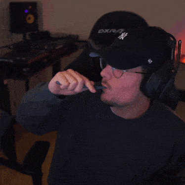 a man wearing a ny hat and headphones