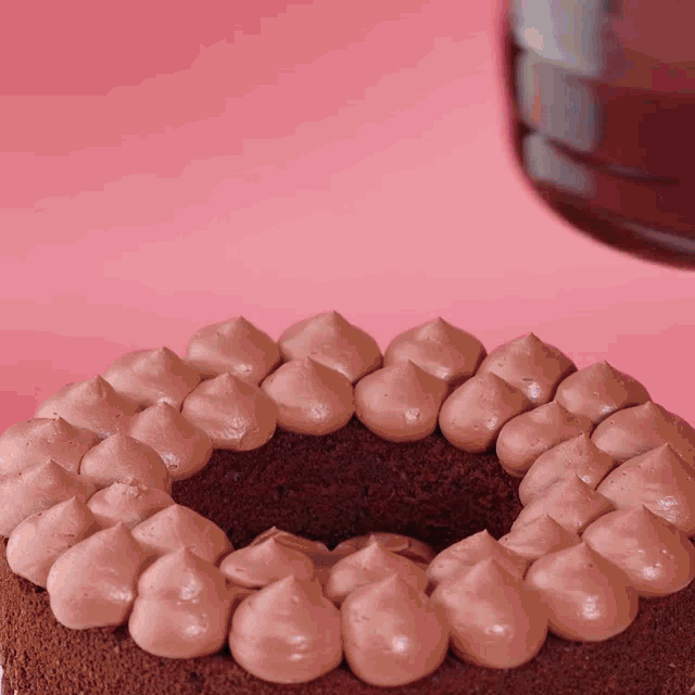 a close up of a cake with chocolate frosting on it