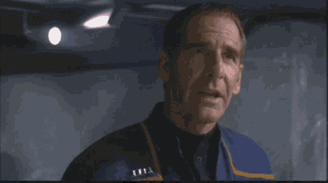 a man wearing a blue jacket with a badge that says a.t.t.a.