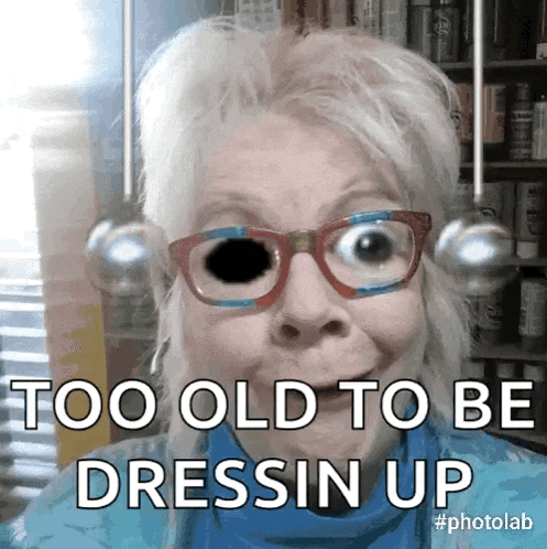 a woman wearing glasses and a blue shirt says too old to be dress up
