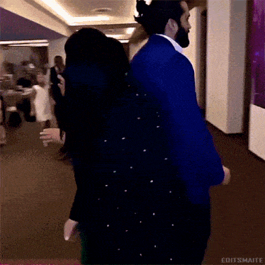 a man and woman are dancing in a hallway with editsmaite written in the corner