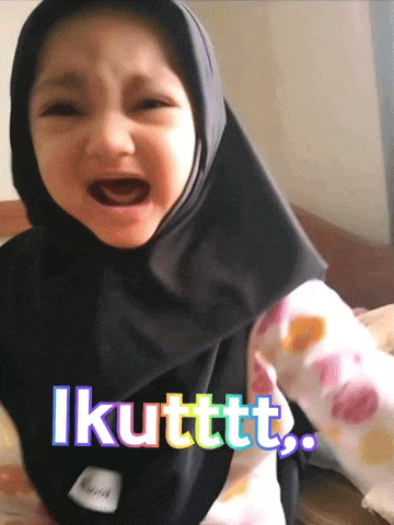 a little girl wearing a black hijab is crying with the words " ikuttt " on the bottom right