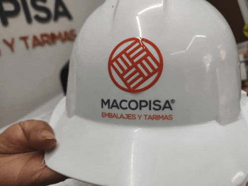 a person is holding a hard hat that says macopisa on it