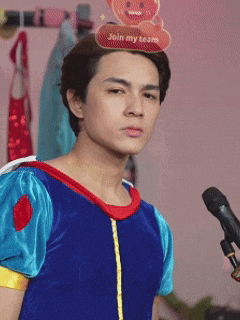 a man in a snow white costume is standing in front of a microphone
