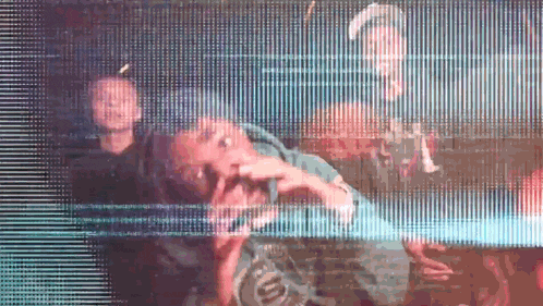 a group of people are standing in front of a screen that says ' supreme '