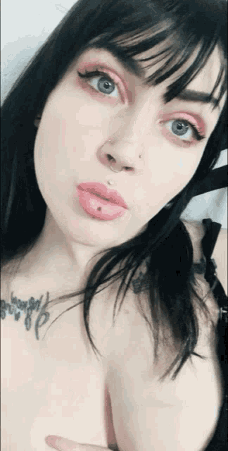 a woman with a tattoo on her shoulder that says ' i love you '