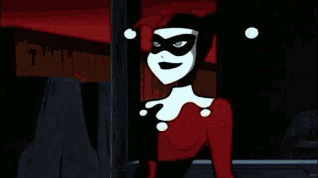 harley quinn from the batman animated series is wearing a red and white outfit and a mask .