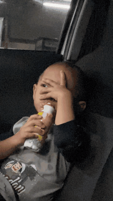 a young boy wearing a shirt that says ' jon ' on it