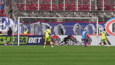 soccer players on a field with an ad for juga bet