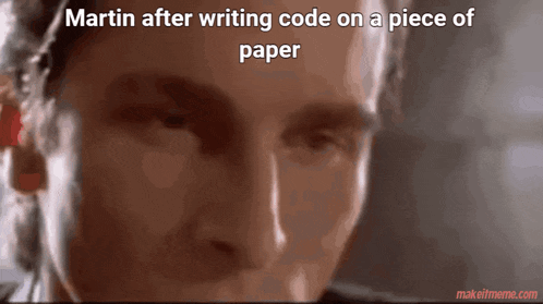 a close up of a man 's face with a caption that says martin after writing code on a piece of paper