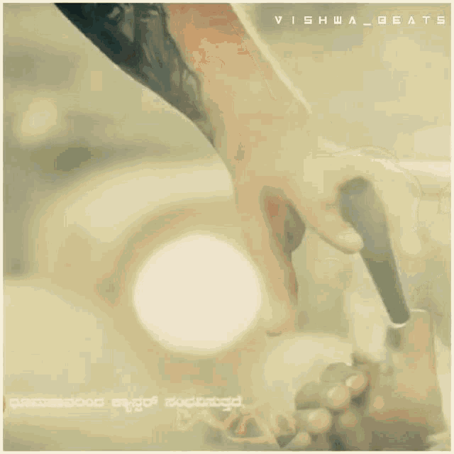 a person is holding a flashlight in their hand with the words vishw_beats on the bottom right