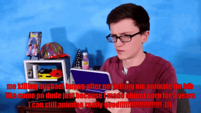 a man with glasses is holding a nintendo 3ds in his hand