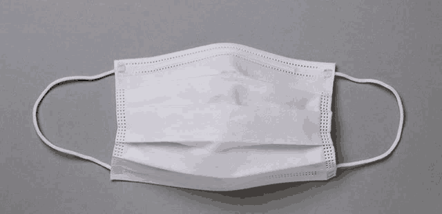 a white face mask is on a gray background