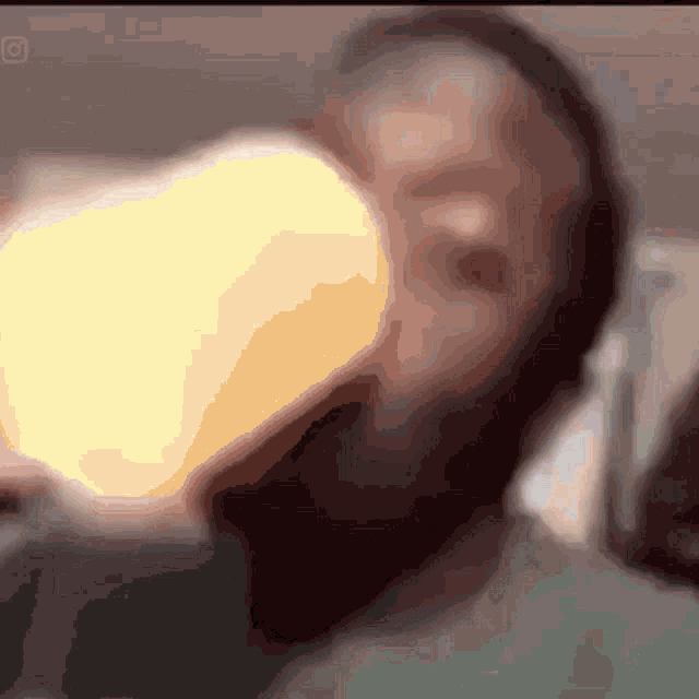 a blurred image of a person drinking from a bottle